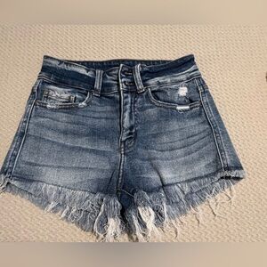 High-Rise Distressed Denim Shorts in Washed Blue